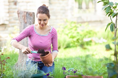 Queensbury gardeners working on a well-kept residential garden